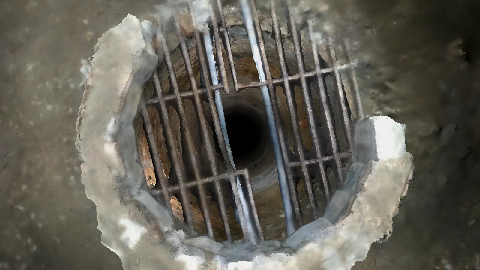 The same grate seen from above, with the shaft dropping away beneath it